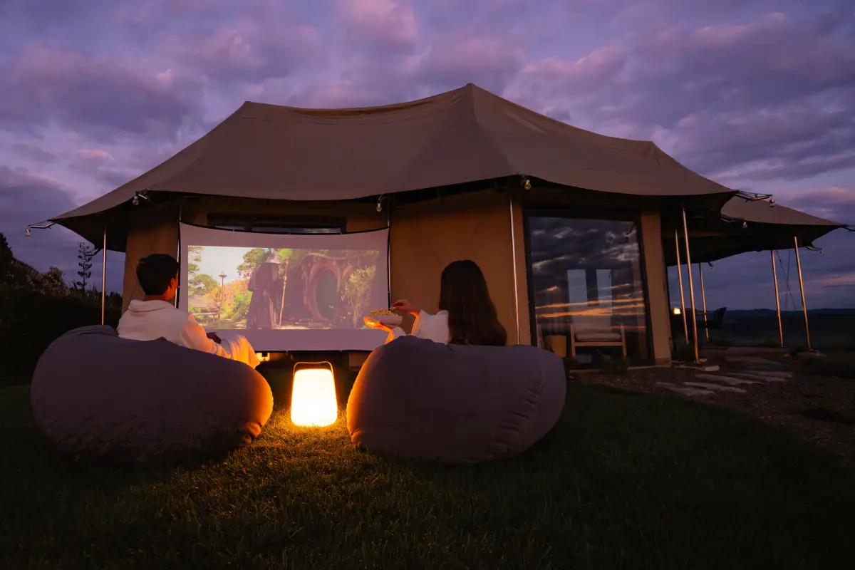 Outdoor movie night at Kōwhai Tent, luxury lodge-style glamping Waitomo