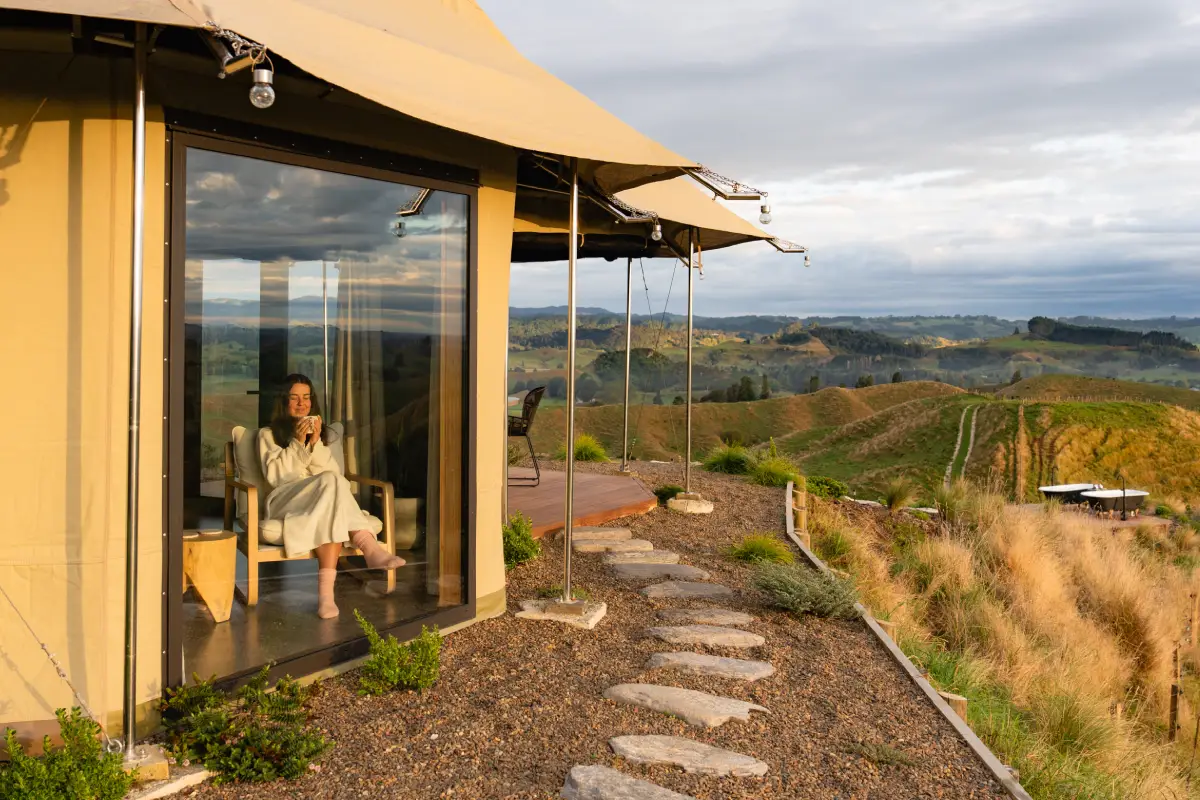 Slow morning in robes at Kōwhai Tent, private accommodation near Waitomo Caves