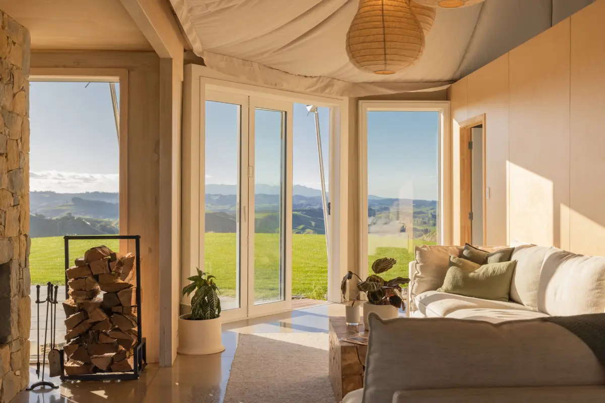 Pōhutukawa Tent kitchen island with leather stools and hilltop views, glamping NZ
