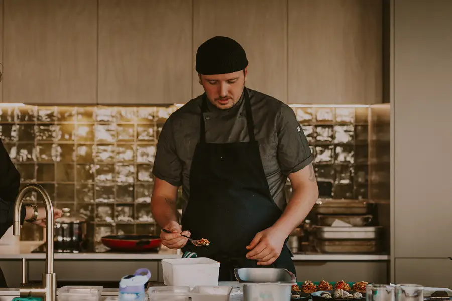 Private chef preparing a gourmet meal at Wild Canvas Pōhutukawa Tent